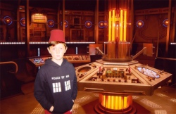 Tom in the Twefth Doctor's TARDIS wearing a Fez.